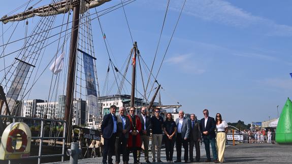 image of group standing beside ship