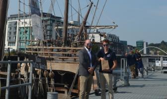 image of 2 people along side ship